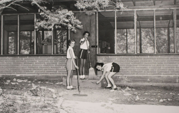 Girl Scouts tidying the front stoop of their cabin
