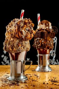 Black Tap | Treat yourself this cookie season to the Mint Brownie Crunch & Coconut Caramel Donut CrazyShakes® at Black Tap Dallas.